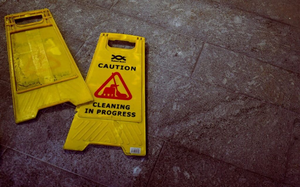 Health and safety signage prominently displayed at a travel venue, emphasizing precautionary measures with clear, bold text