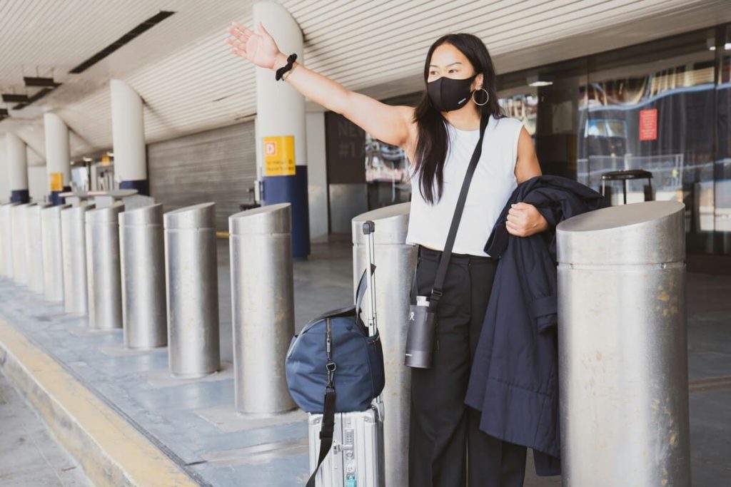 Two travelers wearing protective masks while exploring, demonstrating responsible travel practices during health concerns