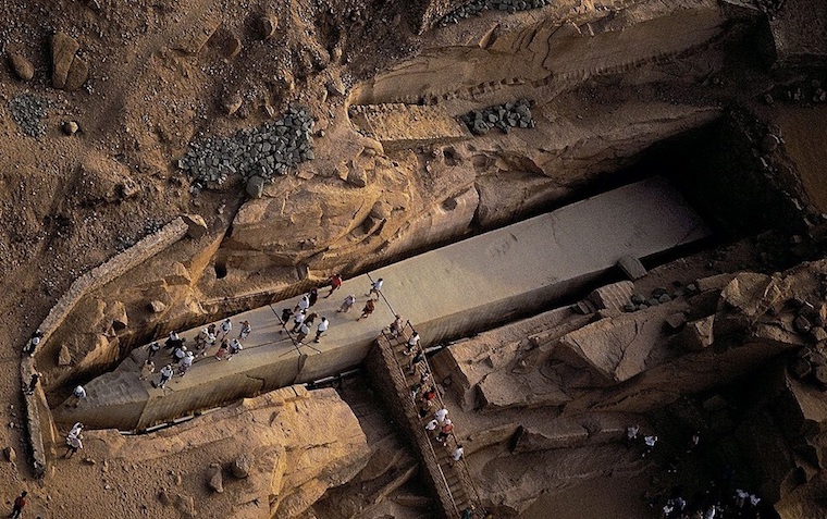 Elevated view of the Unfinished Obelisk at the quarries of Aswan under a dusty sky.