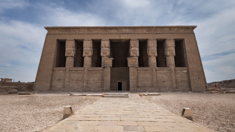 "Massive stone statues at the entrance of an ancient Egyptian temple."