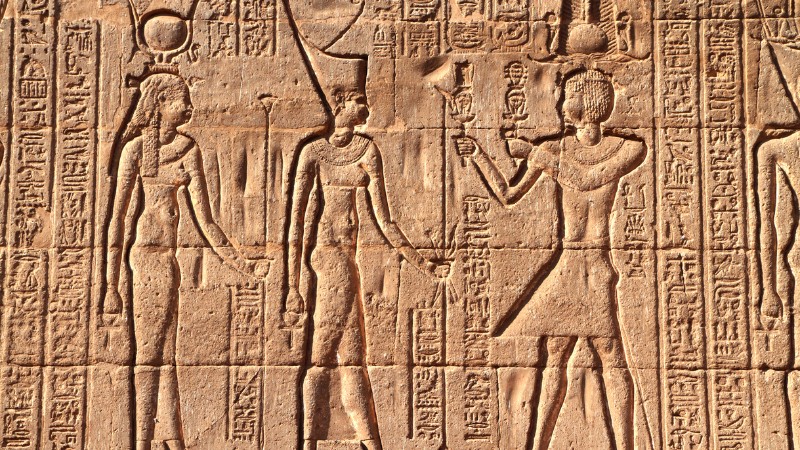 "Hieroglyphic carvings showing an ancient Egyptian embrace."