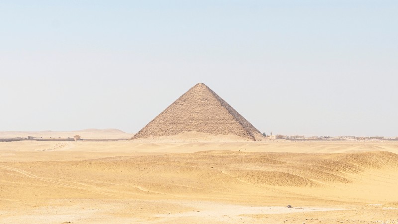 "The Great Pyramid of Giza standing solitary in the vast desert."