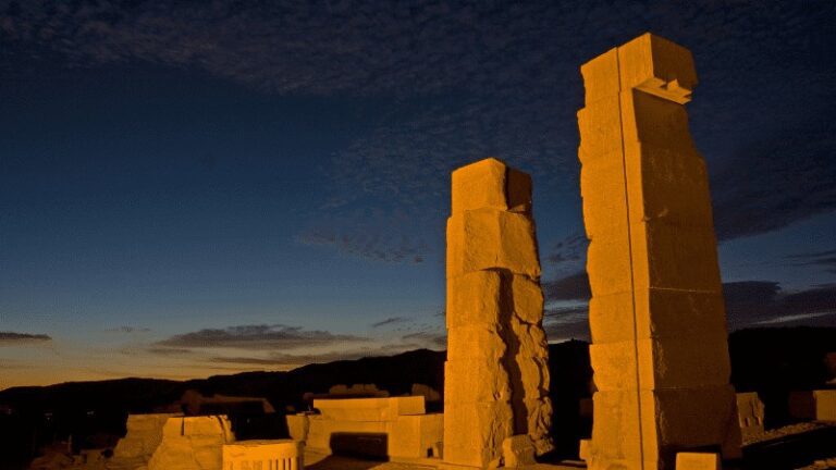 "Two standing pillars at sunset in an ancient Egyptian temple."
