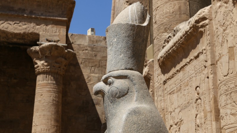 "Stone statue of the Egyptian god Horus at the temple complex."