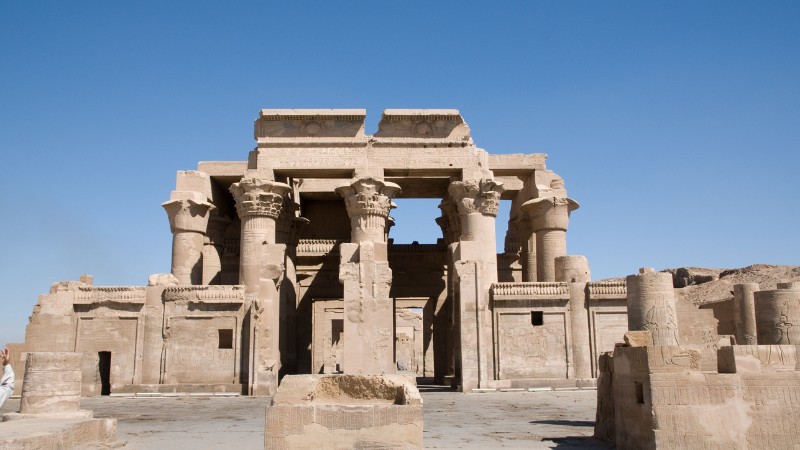 - "Ruins of the double temple at Kom Ombo under the clear sky."
