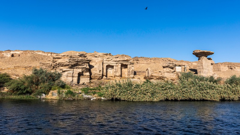 - "Ancient Egyptian tombs by the Nile River's lush banks."