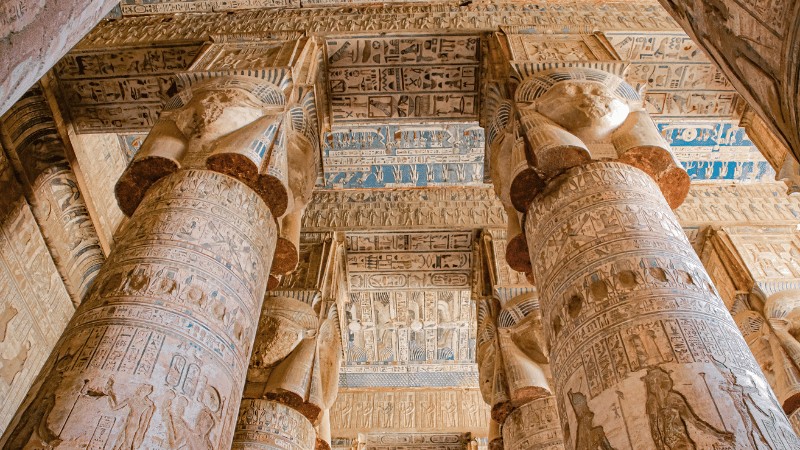 "Intricately carved columns and hieroglyphs in an ancient Egyptian temple."
