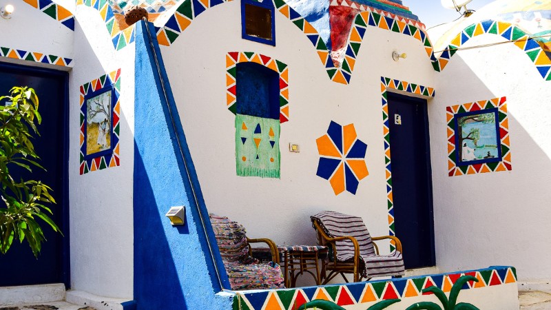 "Colorfully painted Nubian house facade with artistic designs."