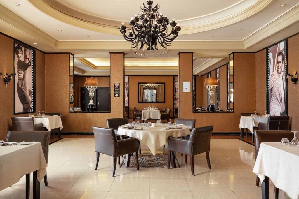 Elegant interior of a high-end dining room with opulent chandelier and framed pictures