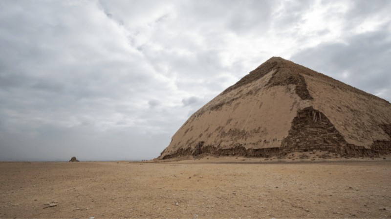 "Image of the Bent Pyramid at Dahshur, Egypt, under a cloudy sky."