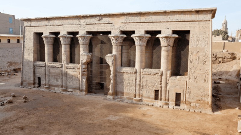 A well-preserved facade of an ancient Egyptian temple with column carvings.