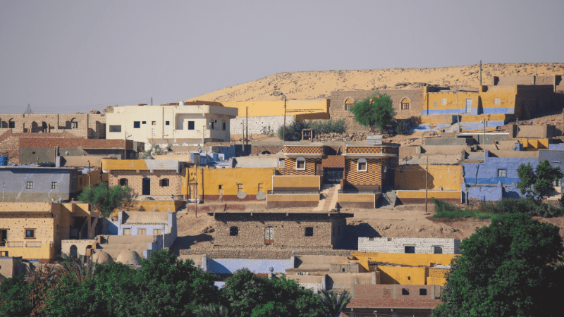 Multi-colored houses of a Nubian village nestled in the desert landscape.