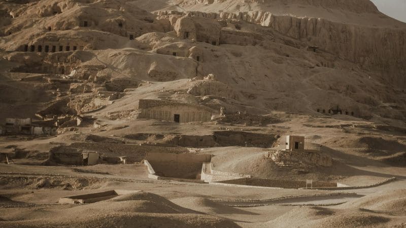 "Sepia-toned view of the ancient tombs in the Valley of the Kings."