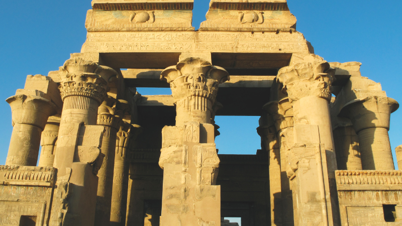 The front columns of Kom Ombo temple under a clear blue sky