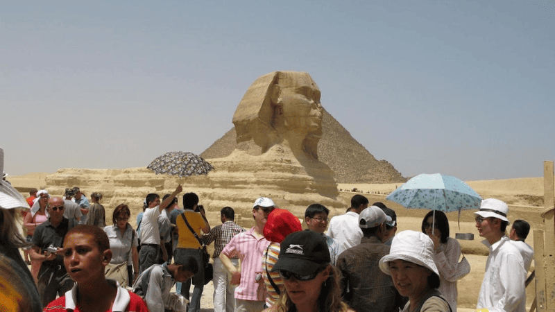 Crowd of tourists near the Sphinx at the Giza pyramid complex