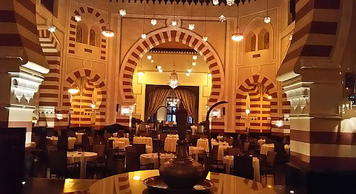 Elegant dining setting inside the 1902 Restaurant with lavish decor, intricate ceiling designs, and a sophisticated ambiance