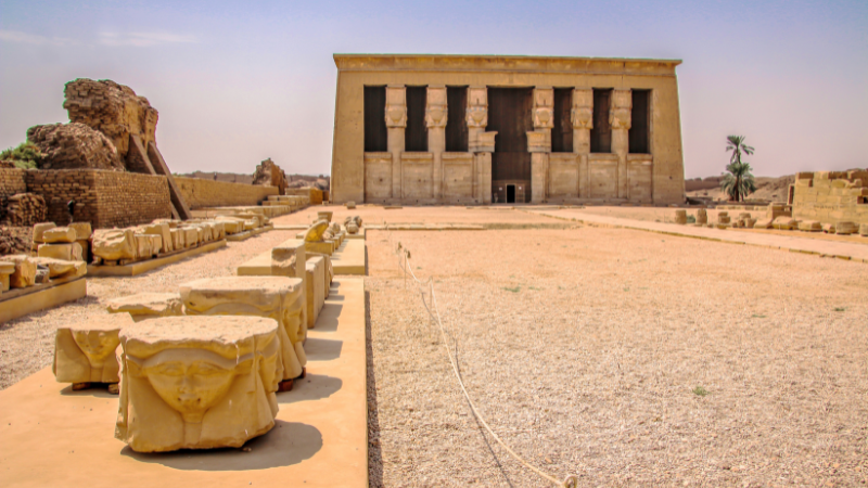 Frontal view of Dendera Temple complex under a clear sky.