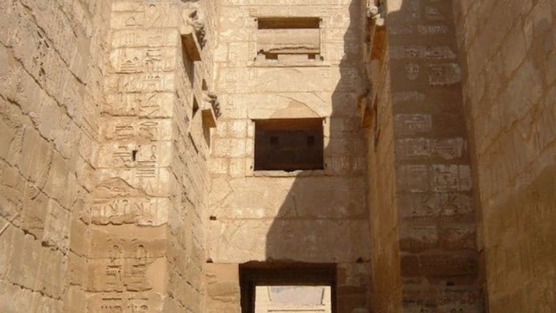 Ancient Egyptian temple interior with hieroglyphic inscriptions