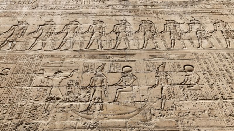 Hieroglyphic engravings on the wall of an ancient Egyptian temple.