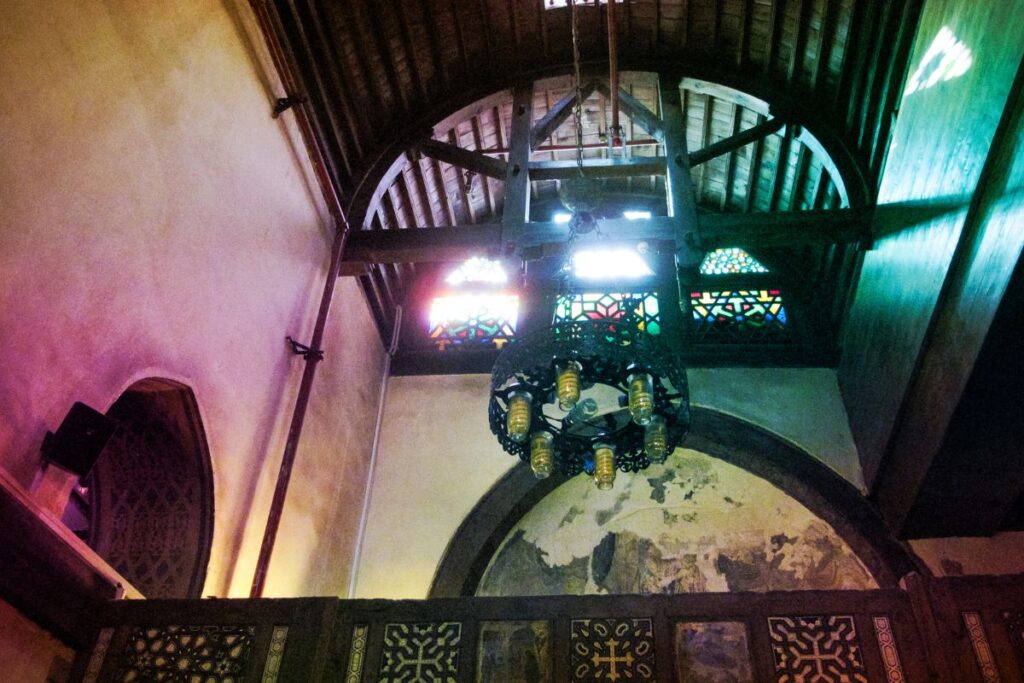 Interior view of an old Coptic church with a hanging lantern.