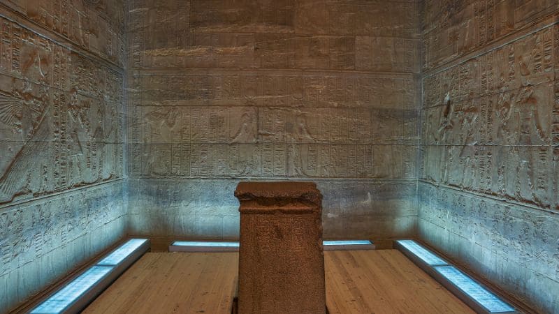 Interior of an ancient Egyptian temple with hieroglyphs.