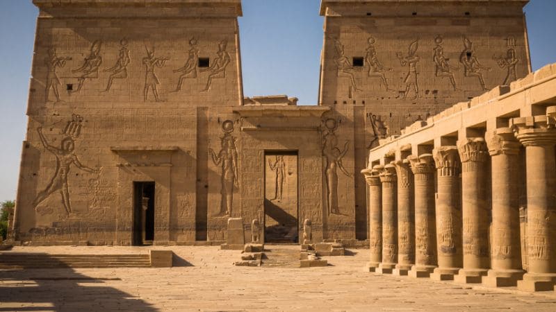 The facade of an Egyptian temple with carvings and columns