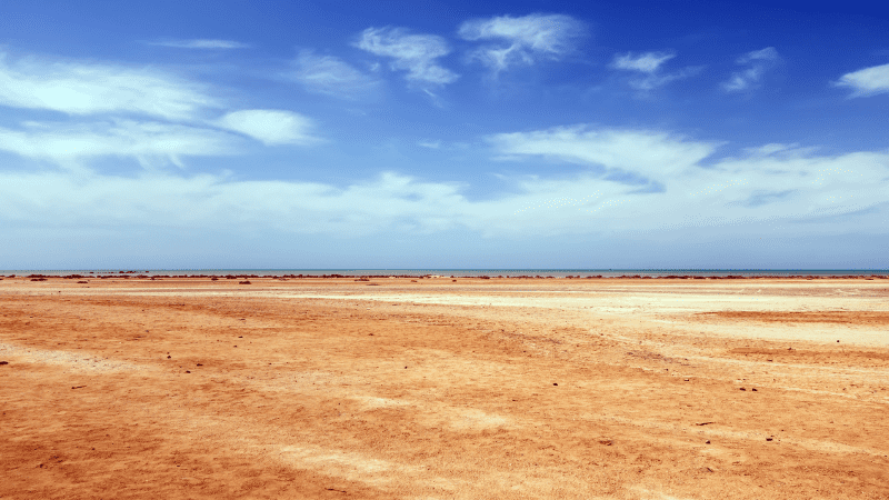 Vast desert landscape under a blue sky.