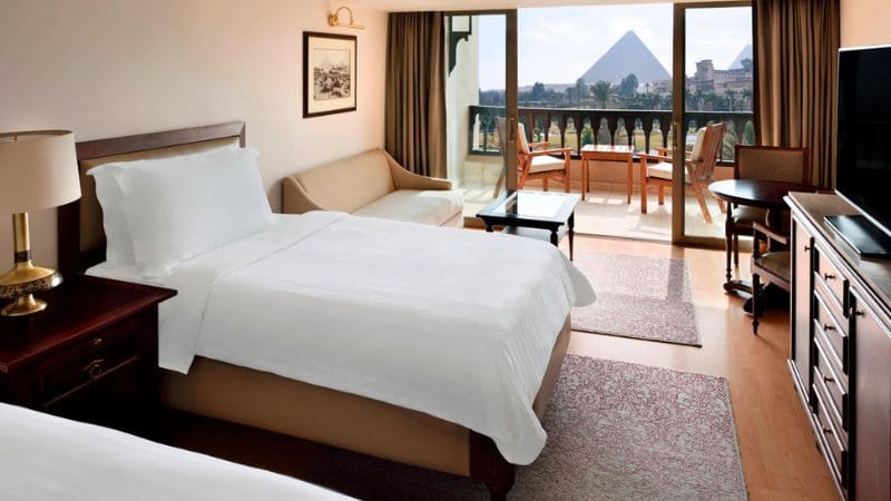 Hotel room with a view of the Pyramids of Giza from the balcony.