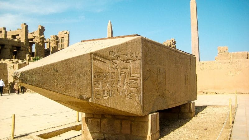 The base of an ancient obelisk etched with hieroglyphs at Karnak Temple.