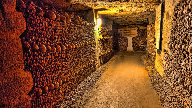 An underground ossuary with walls adorned with patterns made of human skulls and bones