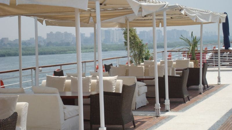 Deck of a Nile cruise boat with lounge chairs.