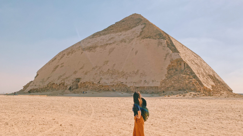 A woman gazing at the Bent Pyramid in Dahshur, Egypt.
