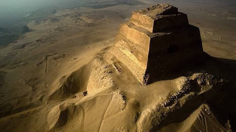 Aerial view of the Meidum Pyramid surrounded by the desert sands