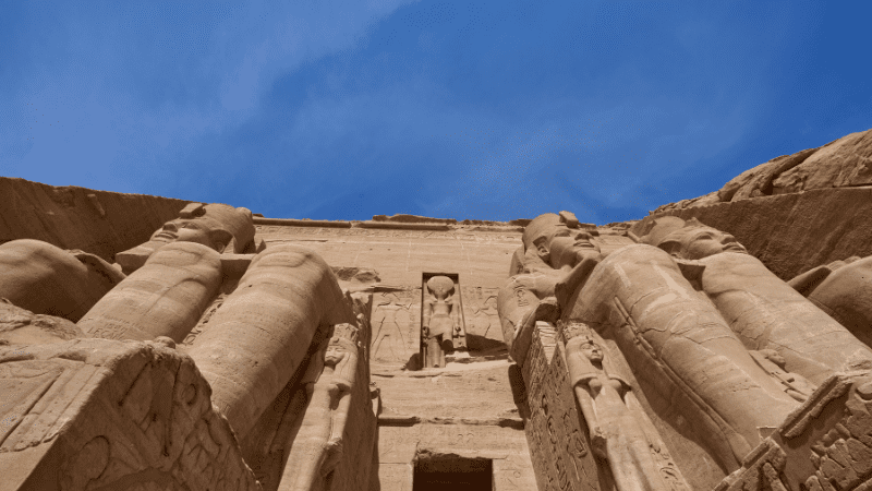 Looking up at the imposing facade of an Egyptian temple