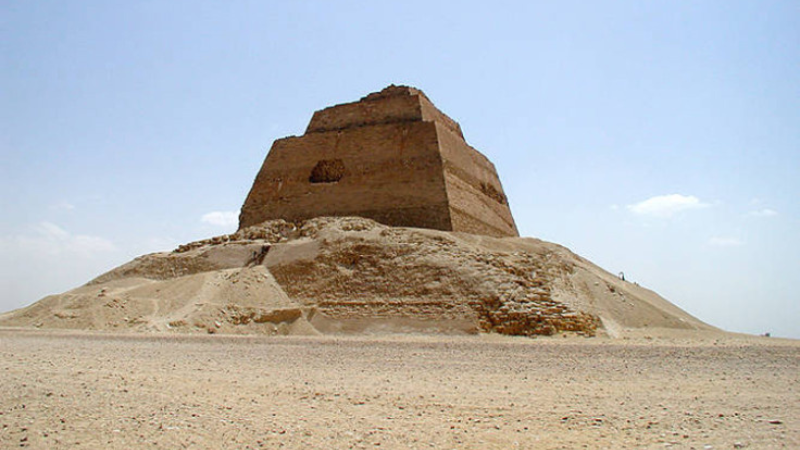 The Meidum Pyramid seen from the ground level, showcasing its unusual form.