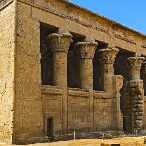 Close-up view of the ancient Esna Temple's intricately carved façade with Egyptian hieroglyphs and column capitals