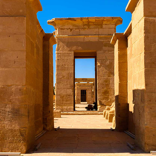 Stone doorway in the Kharga Oasis, Egypt, leading to a clear blue sky