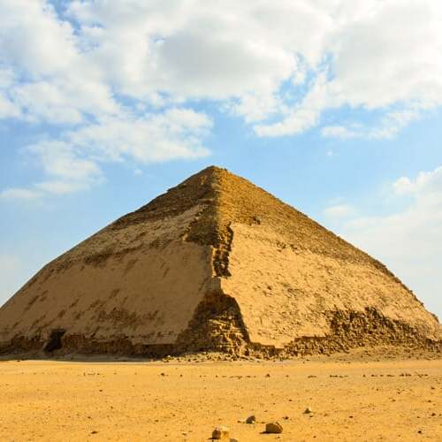 The unique Bent Pyramid with its dual-angle slopes under the clear blue sky at Dahshur, Egypt