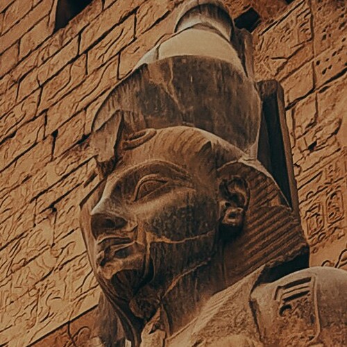 Close-up of an ancient Egyptian pharaoh statue carved in stone