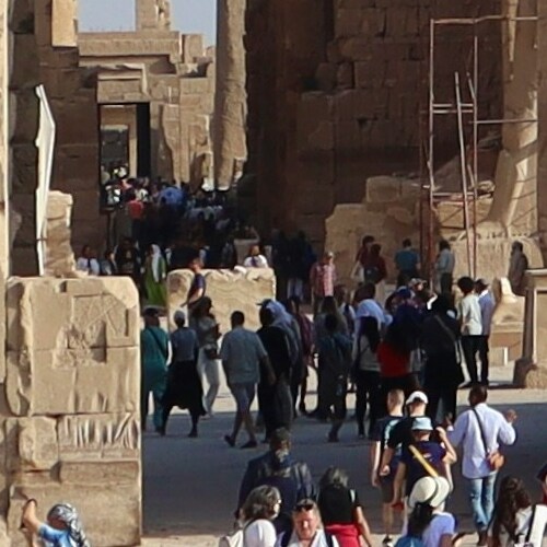 Tourists walking through the historic temple complex of Karnak in Egypt