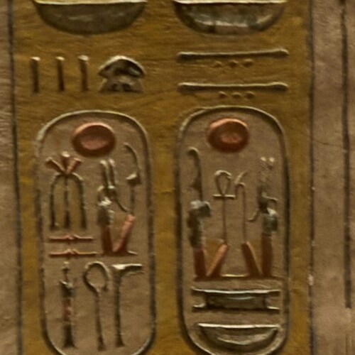 Close-up of two ancient Egyptian cartouches engraved in stone