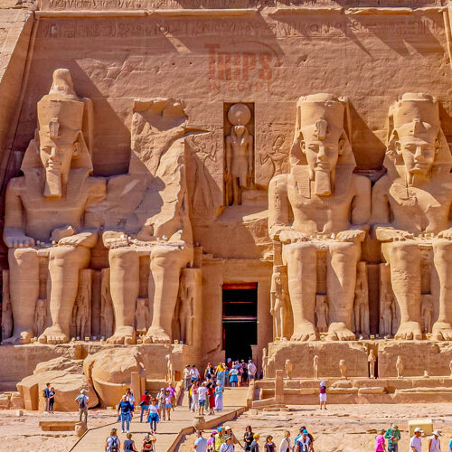 Tourists admiring the colossal statues at Abu Simbel temple in Egypt