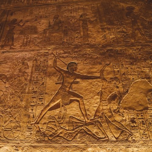 Ancient Egyptian wall carving of a Pharaoh and captives.