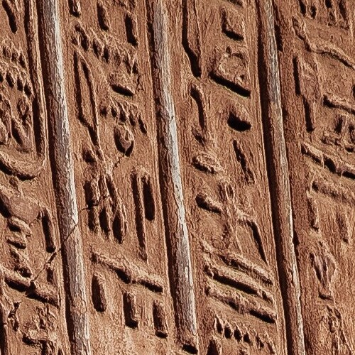 Close-up of an ancient Egyptian hieroglyphic carving on a sandstone wall