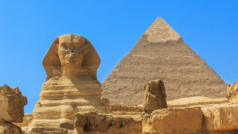 The Sphinx and the Pyramid of Khafre in Giza with a clear blue sky.
