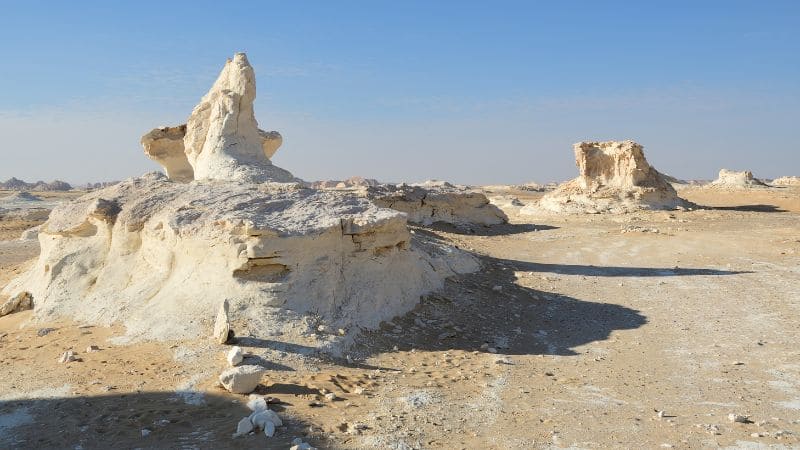 Limestone rock formations in the White Desert of Egypt under a clear sky.
