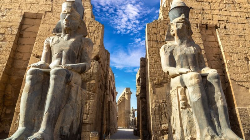 Colossal seated statues of Ramses II at the entrance of Luxor Temple.