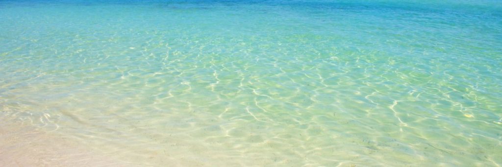 Crystal-clear turquoise waters along the sandy beach of Marsa Matruh, Egypt.