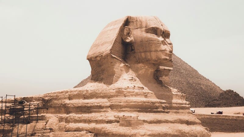 The Great Sphinx of Giza standing guard, with the Pyramid of Khafre in the background, under a clear sky