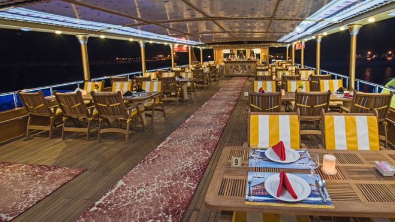 Luxurious dining area on the Nefertari Submarine with elegant tables and chairs.